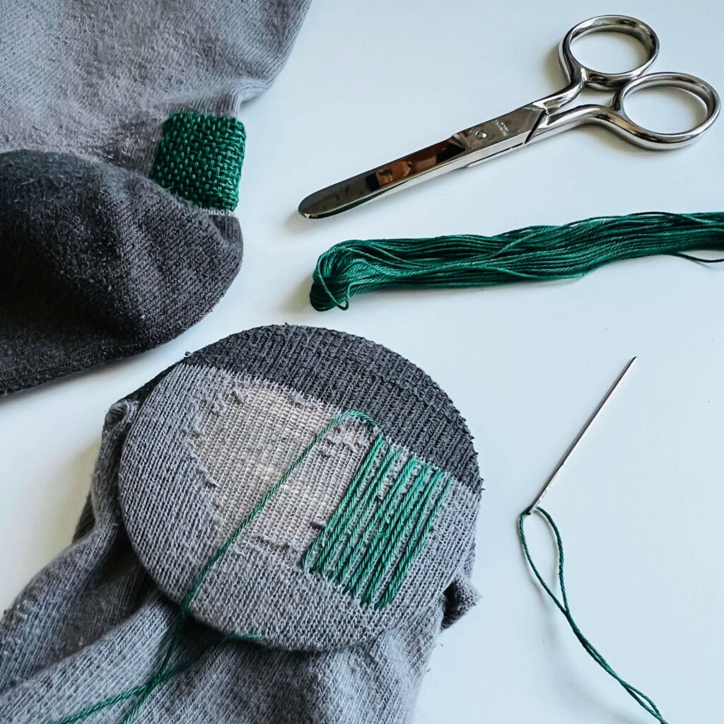 Mending socks with a darning loom